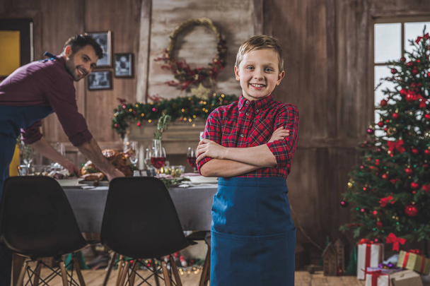 Happy boy near Christmas table  - Фото, изображение