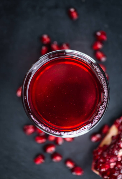 Pomegranate juice on a vintage background  - 写真・画像