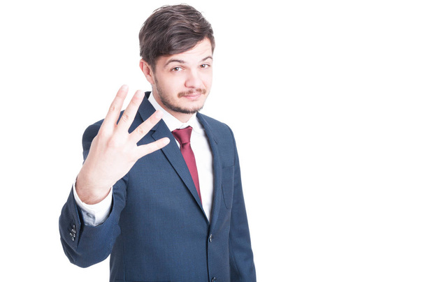 Sales man showing number four with one hand - Foto, afbeelding