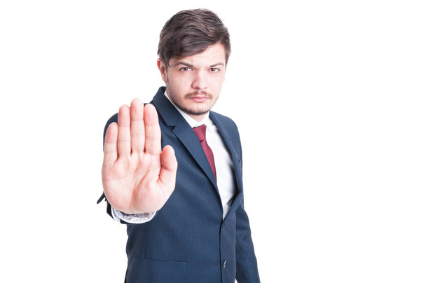 Handsome man wearing suit making stop gesture  - Foto, Imagen