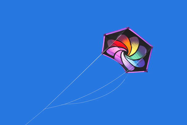 Rainbow colored kite flying high - Photo, Image