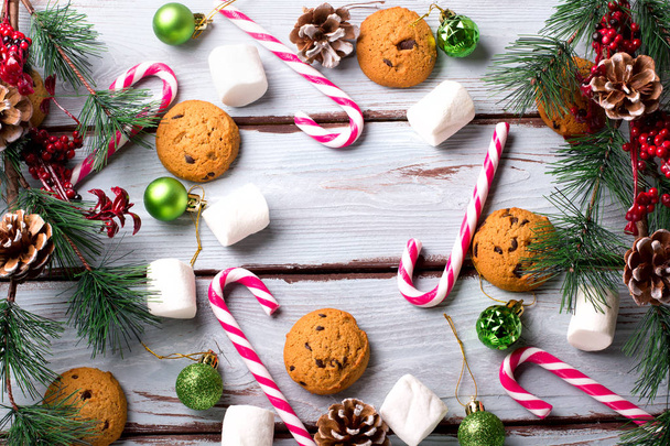 food background with chocolate chip, cookies, marshmallows and candy canes - 写真・画像