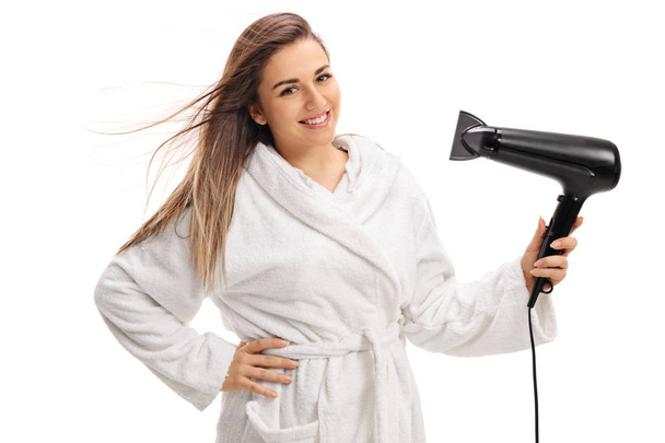 Joyful woman drying her hair with a hairdryer - Fotoğraf, Görsel