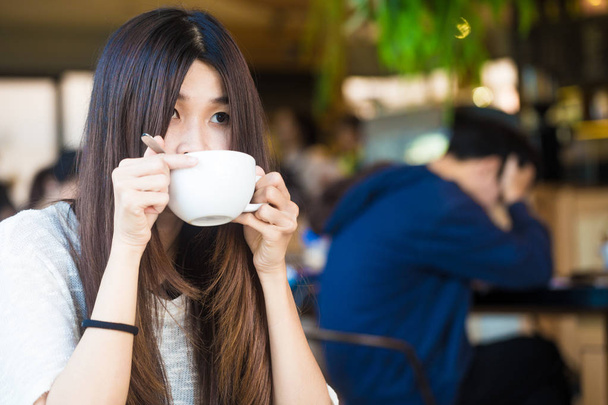 Coffee library portrait of asian university woman drinking latte - Photo, Image