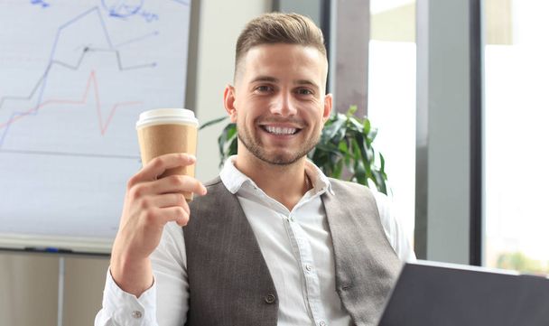 Modern businessman drinking coffee in the office  - Photo, image