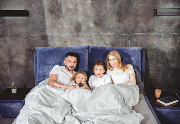 Happy family in bed      - Фото, зображення