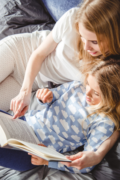 Mother and daughter reading book  - Fotoğraf, Görsel