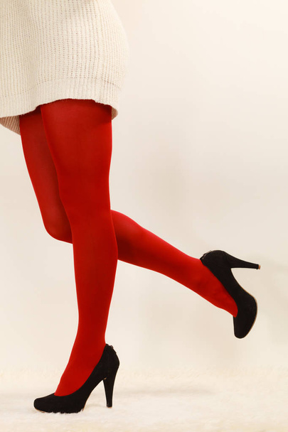 woman legs in red vivid color pantyhose black high heels shoes - Foto, afbeelding
