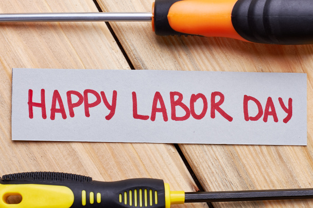 Screwdrivers and Labour Day card. - Фото, изображение
