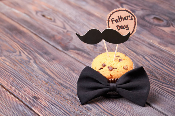 Bow tie near muffin. - Photo, Image
