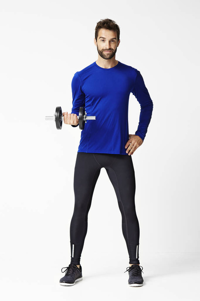 Man exercising with dumbbell  - Фото, зображення