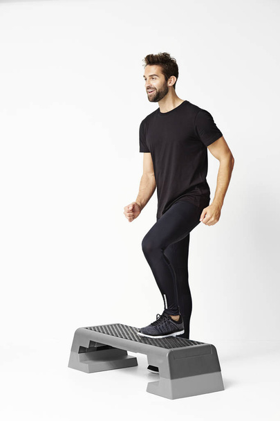Man stepping on exercise step - Photo, Image