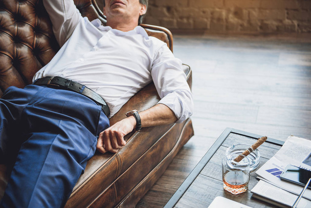 Tired man lying on couch - Foto, Imagen
