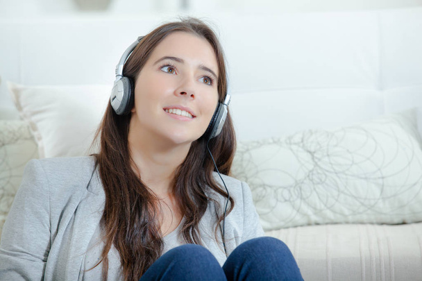 Brunette with headphones daydreaming - Photo, Image