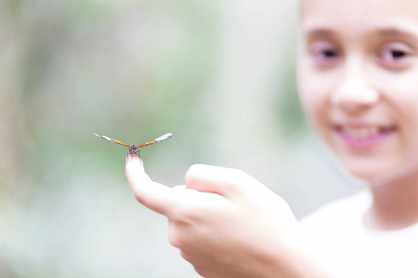 Happy Girl Holding a Butterfly - Φωτογραφία, εικόνα