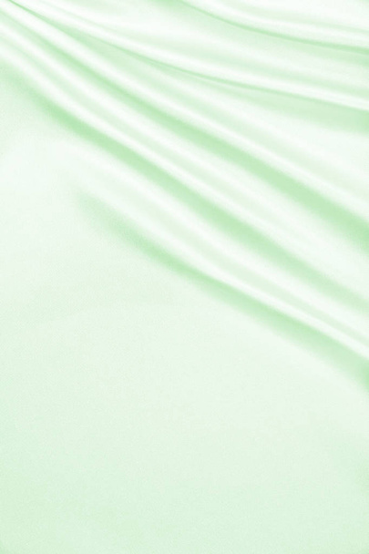 滑らかなエレガントな緑色の絹またはサテンの高級布テクスチャとして単 - 写真・画像