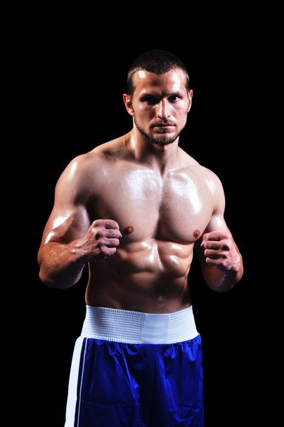 Powerful muscular boxer posing on black background - Fotoğraf, Görsel