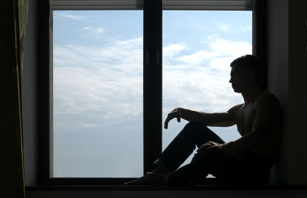 Silhouetted Man on the Windowsill - Foto, Imagen