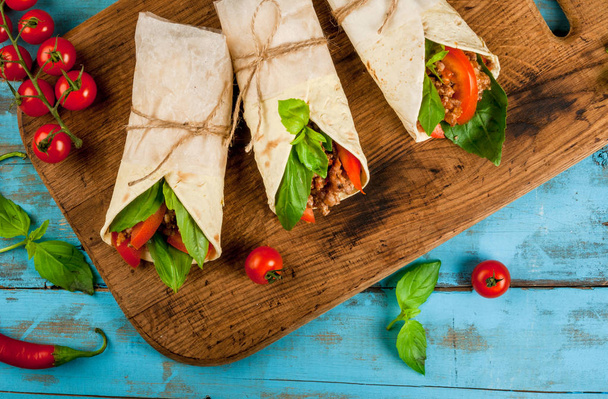 Healthy lunch snack. Sandwiches twisted roll Tortilla with beef  - Photo, Image