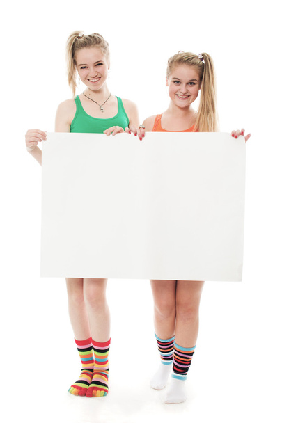 Two cheerful girls hold the form - Foto, immagini