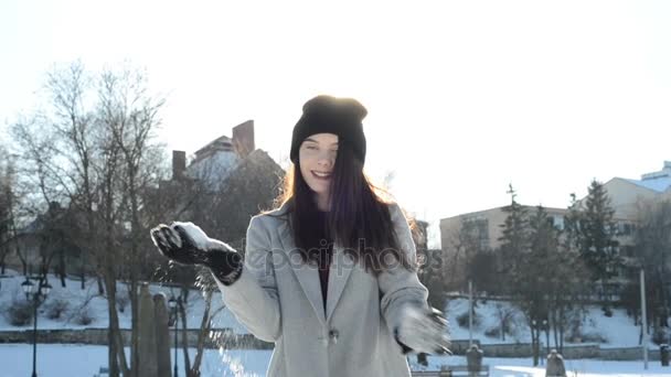 young beautiful woman playing with snow - Video, Çekim