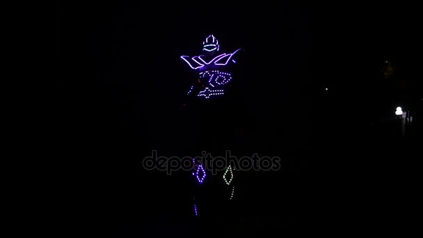 a Clown in the Led Light Costume on the Stilts Dancing at Night. - Footage, Video