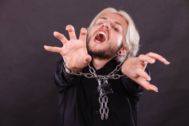 Screaming man with chained hands, no freedom - 写真・画像