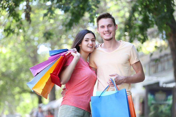 Happy couple with shopping bags   - Photo, image