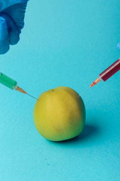 Chemical additives in food or genetically modified fruit concept. - 写真・画像
