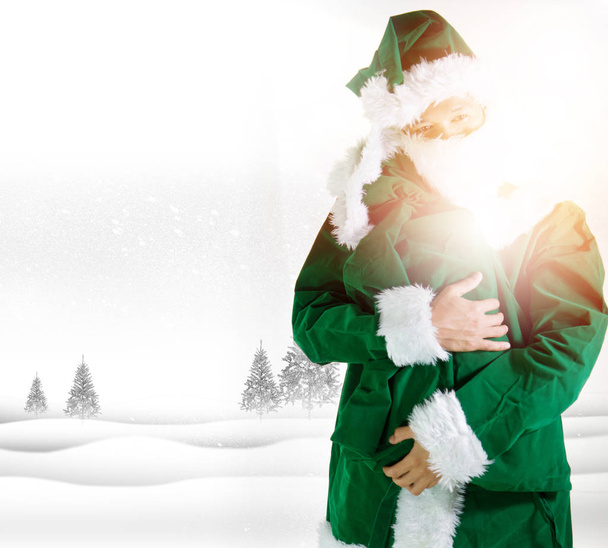 Père Noël en costume vert avec sac
 - Photo, image