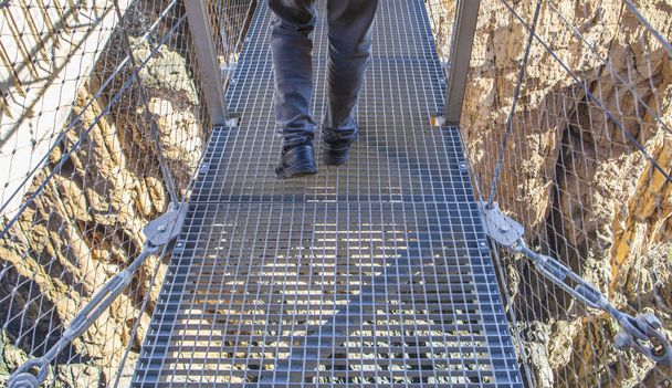 Trekking shoes on suspension bridge at Caminito del Rey - Photo, Image