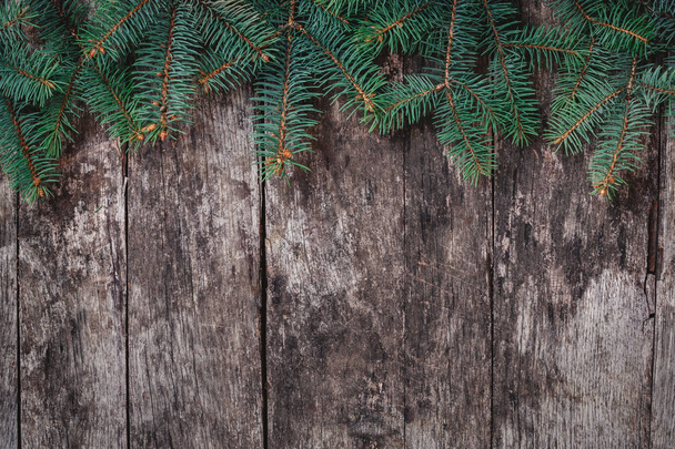 Christmas Fir branches on wooden background. Xmas and Happy New Year composition. Flat lay, top view. Copy space - Φωτογραφία, εικόνα