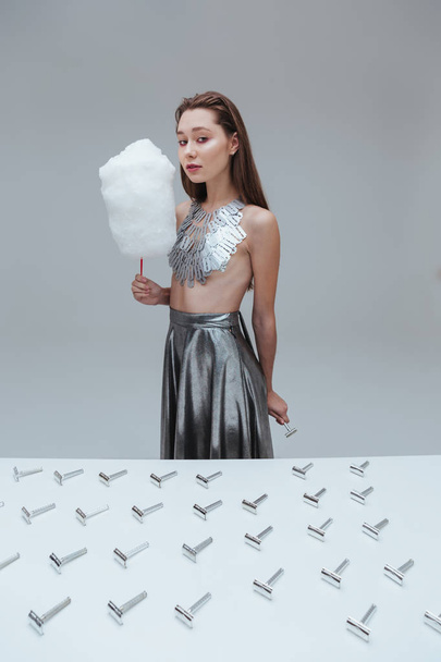 Woman in blade necklace with cotton candy and vintage razor - Fotografie, Obrázek