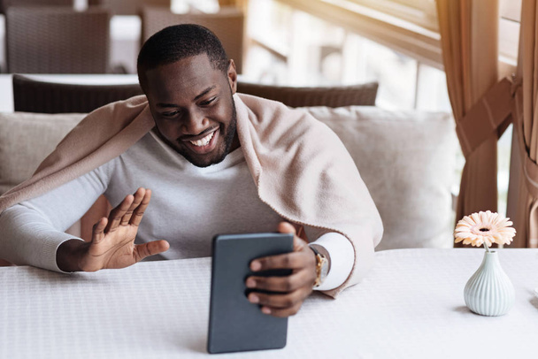 Cheerful African American man having the conversation via the Internet - Φωτογραφία, εικόνα