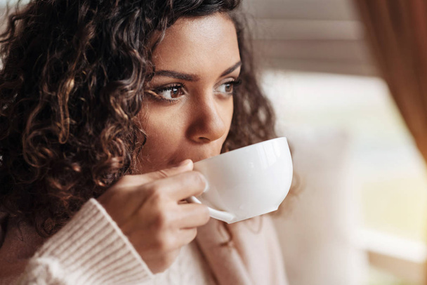 Involved African American woman drinking the cup of tea - Фото, зображення
