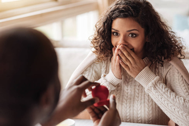 Shocked African American woman getting the proposal from her boyfriend - Φωτογραφία, εικόνα
