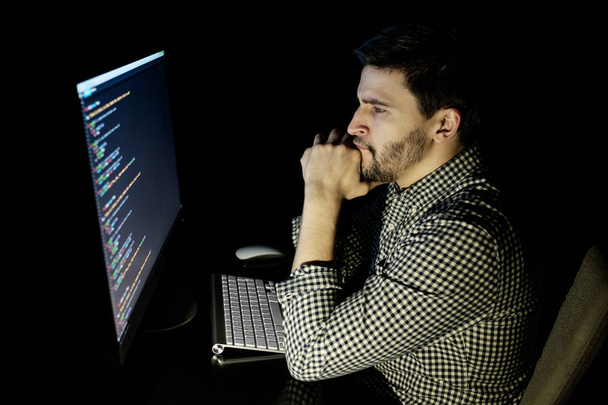 Software developer computer at dark home office - Фото, изображение