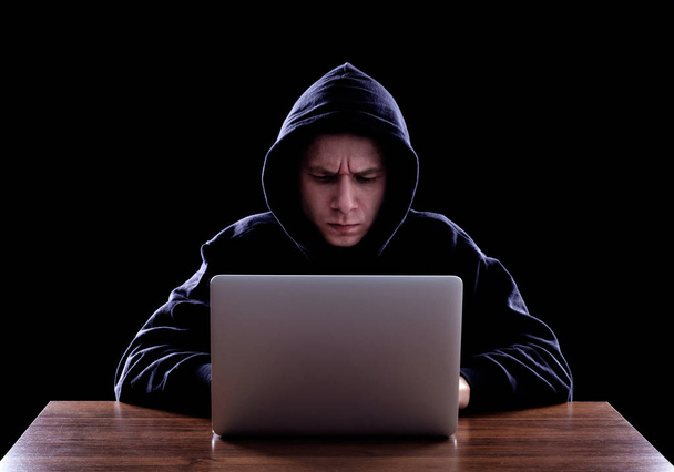 Hooded computer hacker stealing information - Photo, image