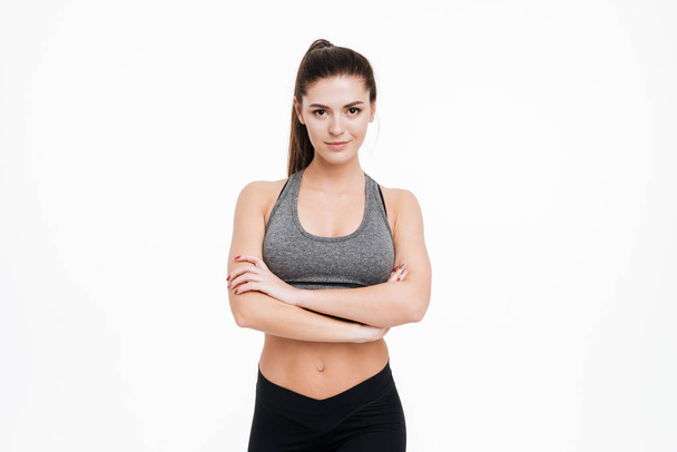 Sports woman standing with arms folded and looking at camera - Foto, imagen