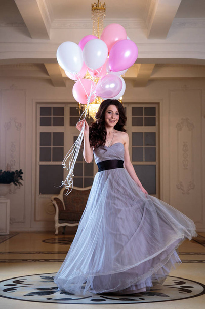 beautiful young woman in luxury evening dress with air balloons in interior - Φωτογραφία, εικόνα