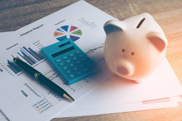 Piggy bank with business stuff, business and finance concept, vintage color tone. - 写真・画像