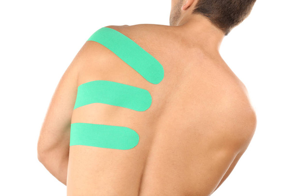 Physio tape applied onto male scapula, isolated on white - Fotó, kép