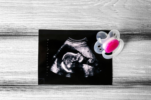 Ultrasound photo and pacifier - Foto, afbeelding