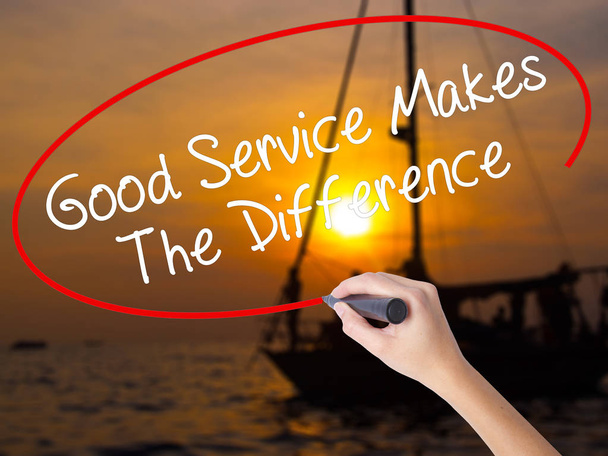 Woman Hand Writing Good Service Makes The Difference with a mark - Photo, Image
