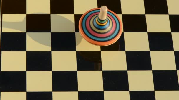 Wooden whirligig rotate on chessboard - Footage, Video
