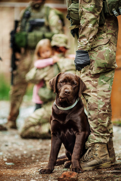 Military Man Hugs Dog - Фото, изображение