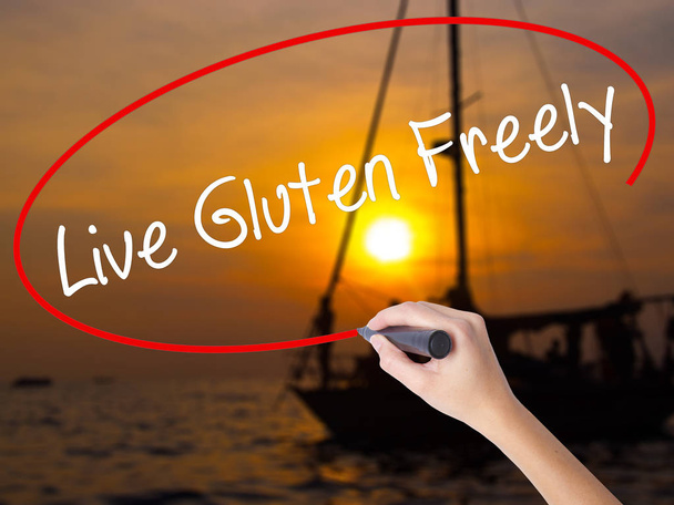 Woman Hand Writing Live Gluten Freely with a marker over transpa - Photo, Image