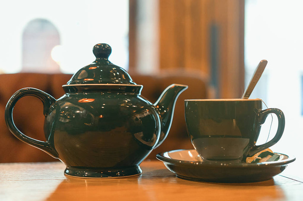 Cup of tea with teapot on the table - Foto, immagini