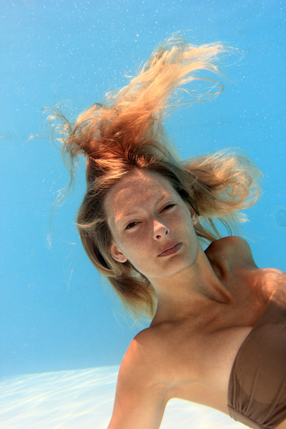 Woman swimming underwater - Фото, изображение