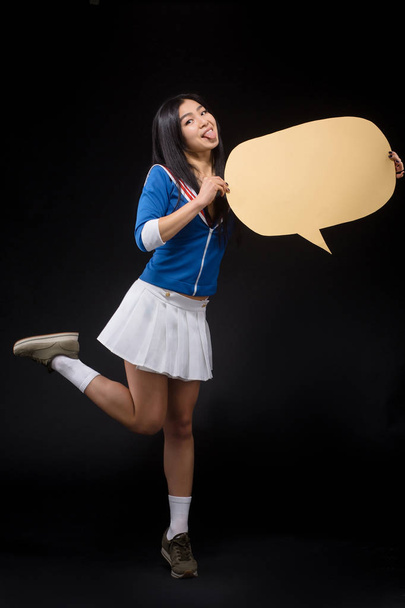 Asian woman posing with blank poster in studio - Фото, зображення